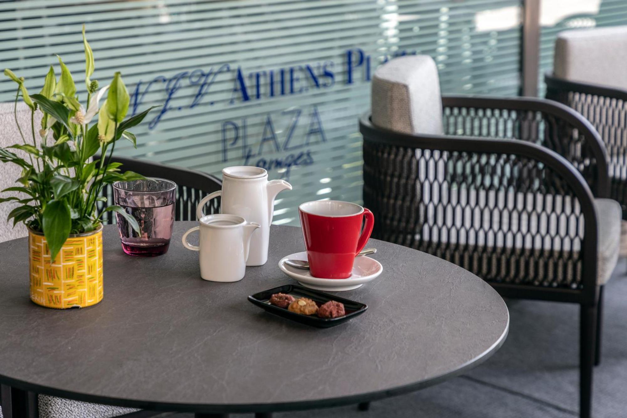 Njv Athens Plaza Hotel Luaran gambar A coffee table with a red mug